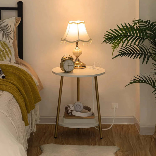 Round nightstand with lamp, clock, and headphones in a bedroom setting.