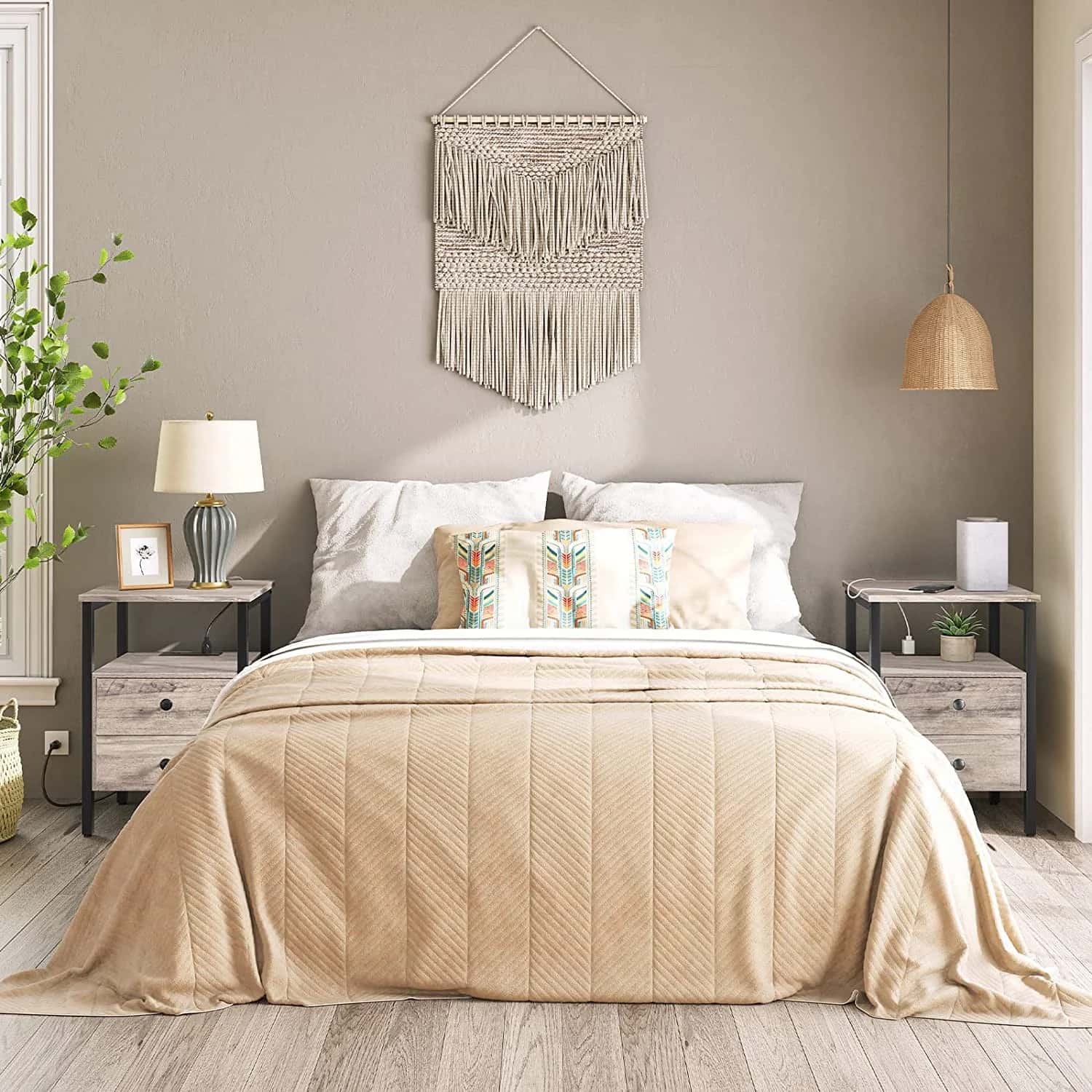 Neatly made bed with beige bedding in a bedroom setting.