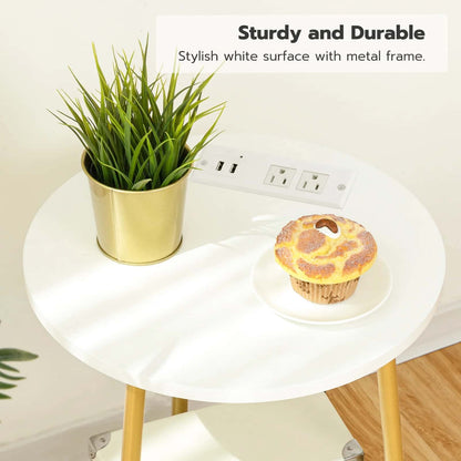 Round white table with gold legs, plant, and cupcake on a light background