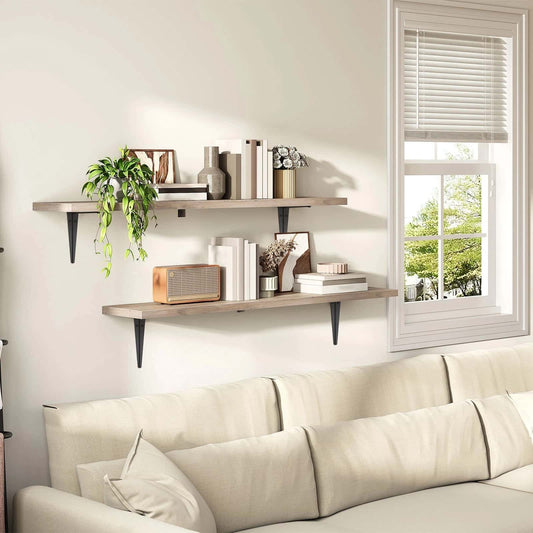 Living room with a beige sofa, wooden shelves, and a window with blinds.