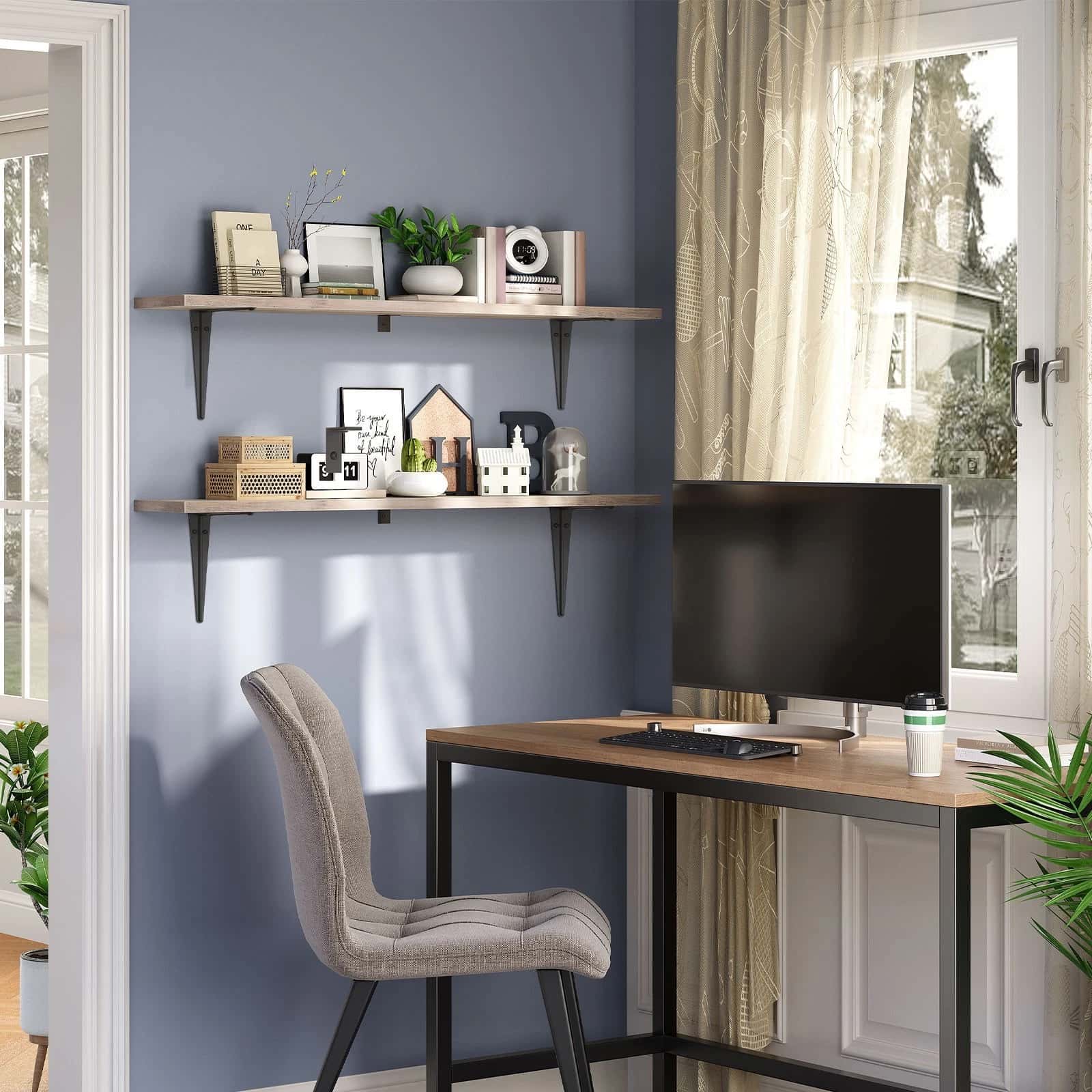 Home office with a desk, chair, and shelves against a blue wall.