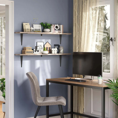 Home office with a desk, chair, and shelves against a blue wall.