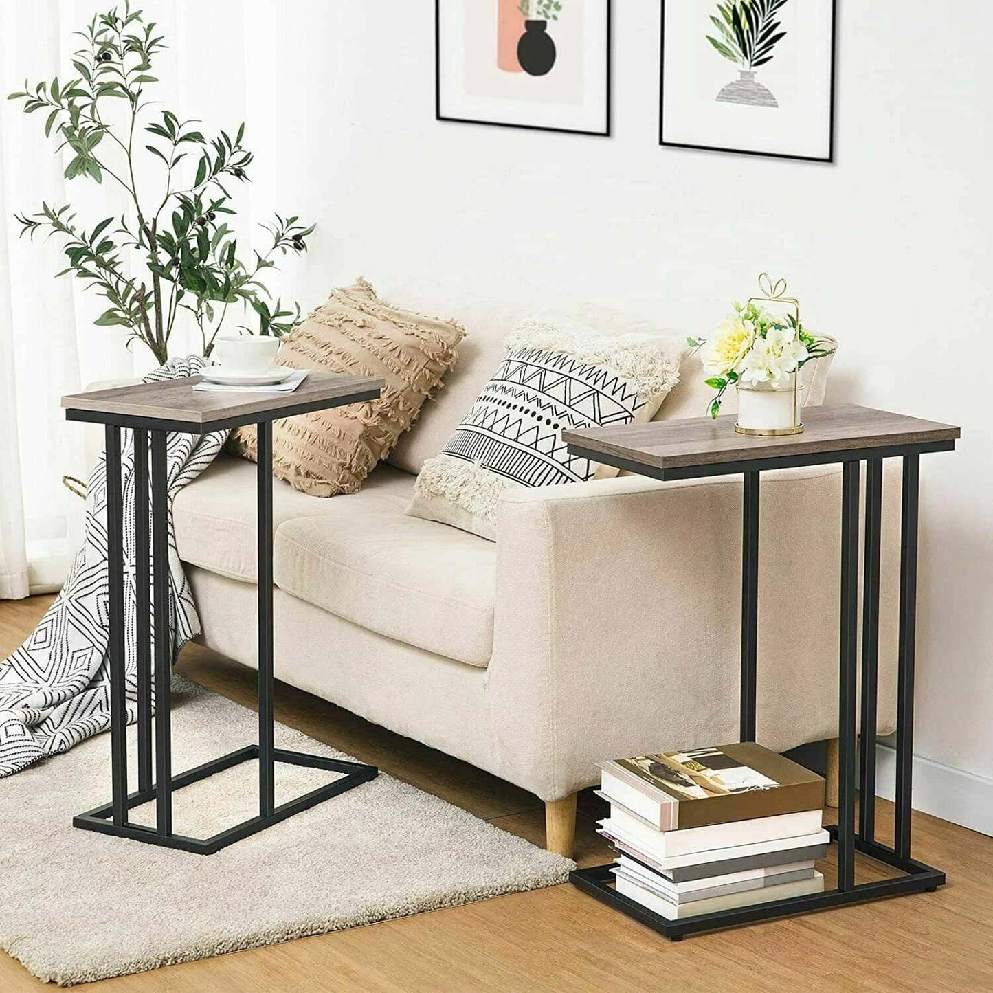 Two side tables in a living room setting with a sofa and decor items.