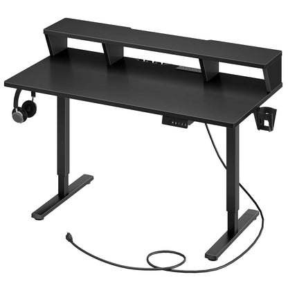 Black computer desk with shelves and cable management on a white background