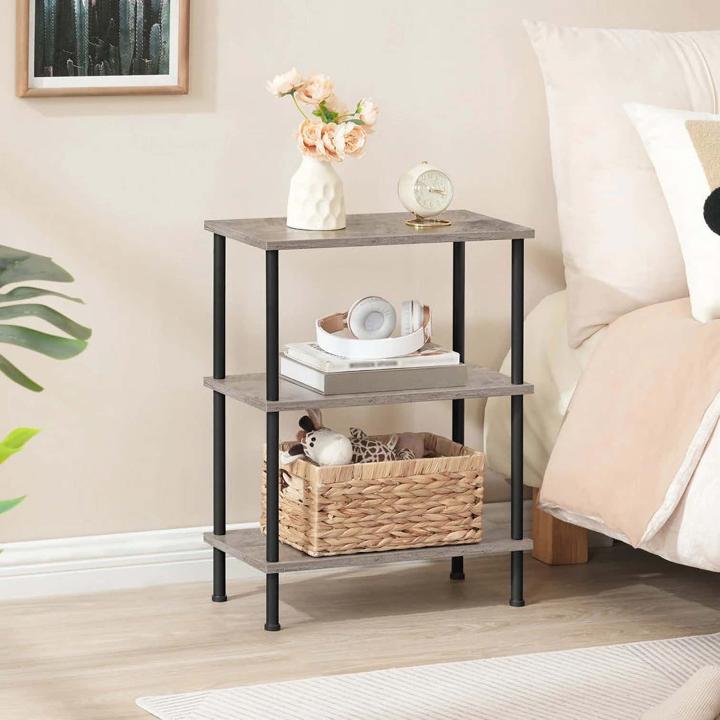 Three-tier end table with decorative items in a bedroom setting