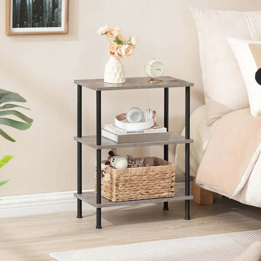 Three-tier end table with decorative items in a bedroom setting