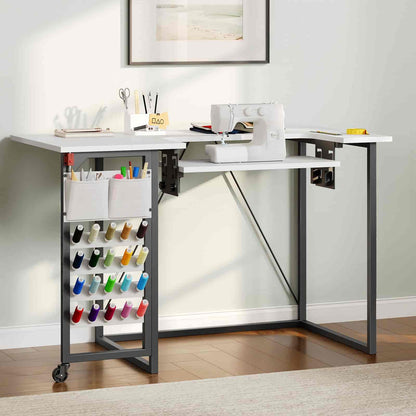 White sewing table with a rolling cart for supplies in a home setting.