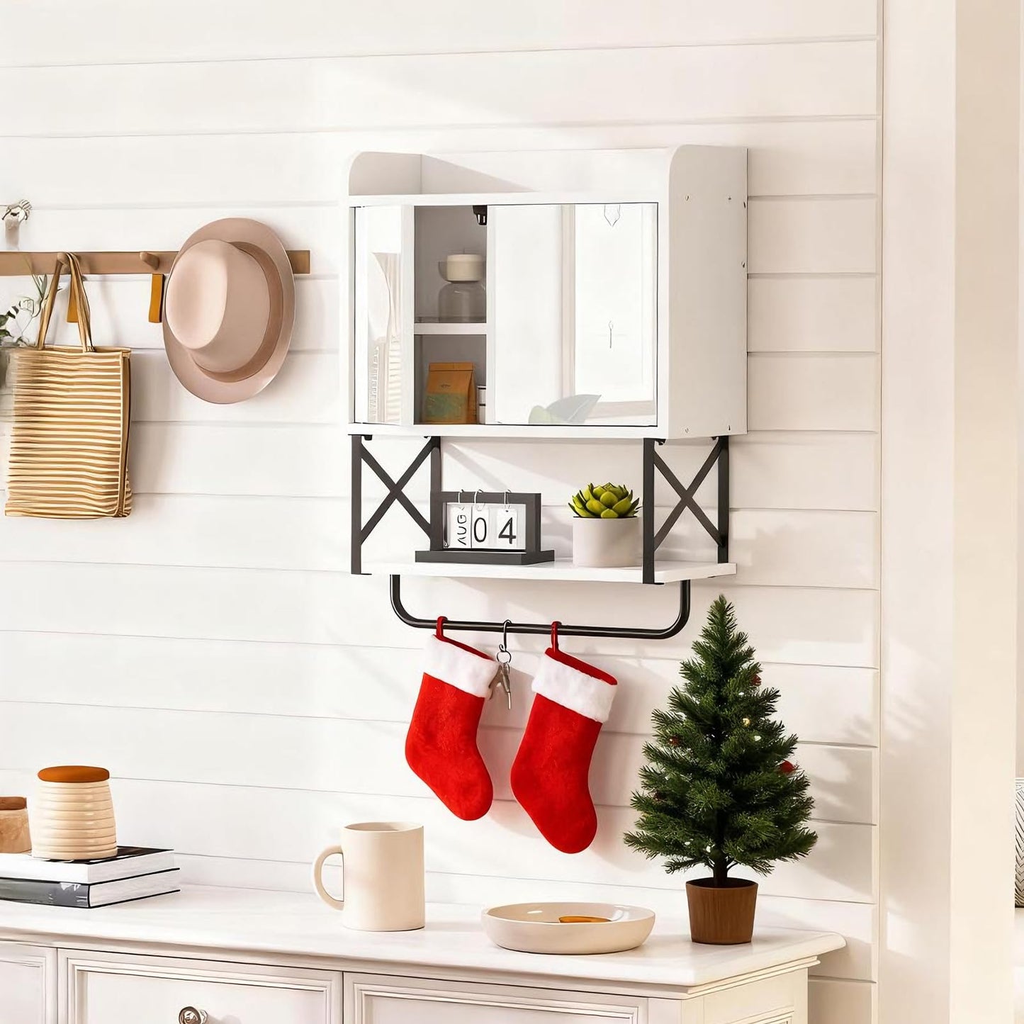 Decorative wall shelf with stockings, small Christmas tree, and festive decor in a home setting.