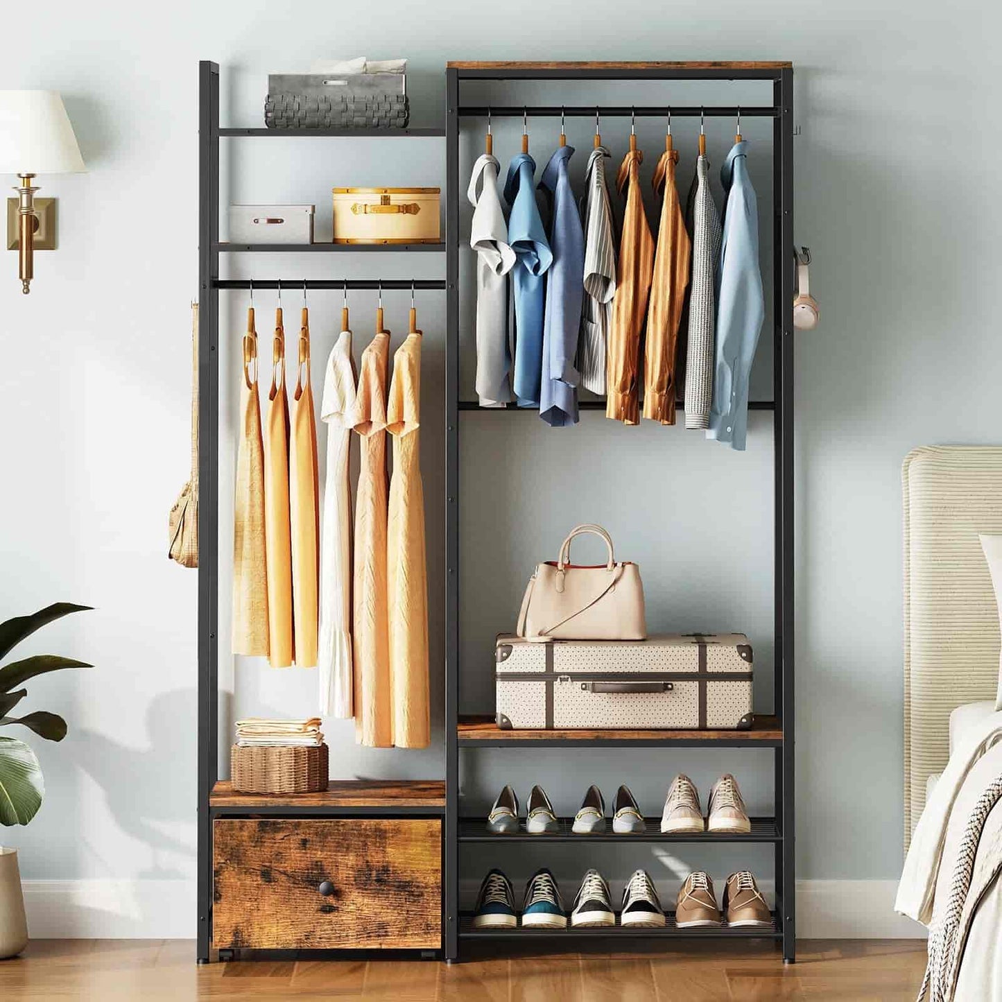 Clothing rack with clothes, shoes, and bags in a room setting.