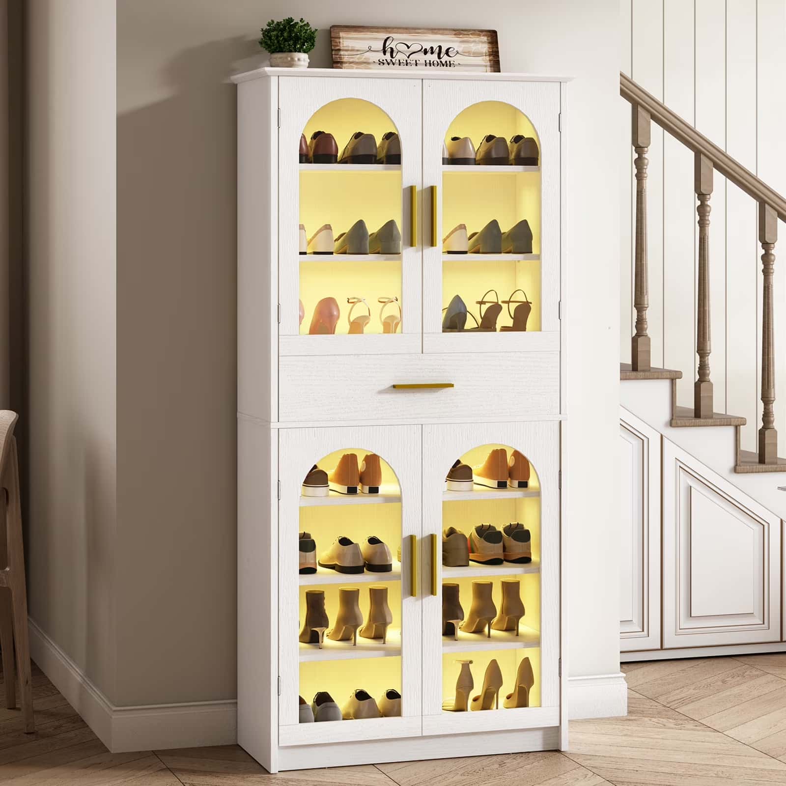 White shoe cabinet with glass doors displaying shoes in a home setting.