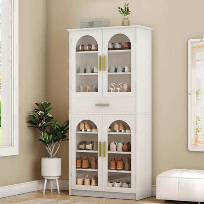 White cabinet with glass doors displaying various items in a room with a plant and ottoman.