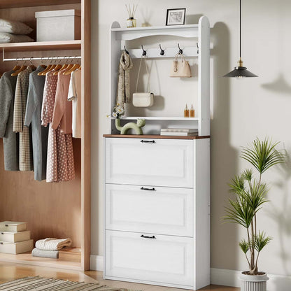 Closet with white dresser, hanging clothes, and a plant.