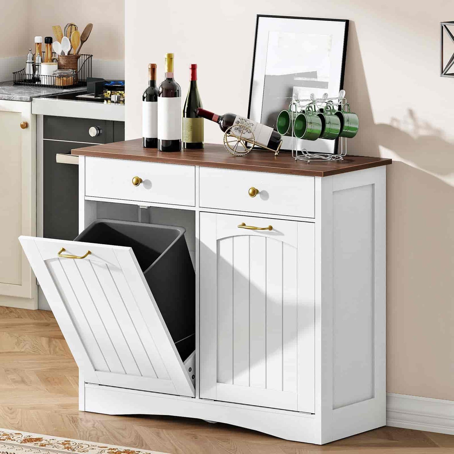 White kitchen cabinet with a pull-out trash bin, wine bottles, and glasses on a wooden countertop.