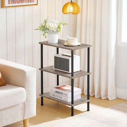 Three-tiered wooden shelf with decorative items in a living room setting.