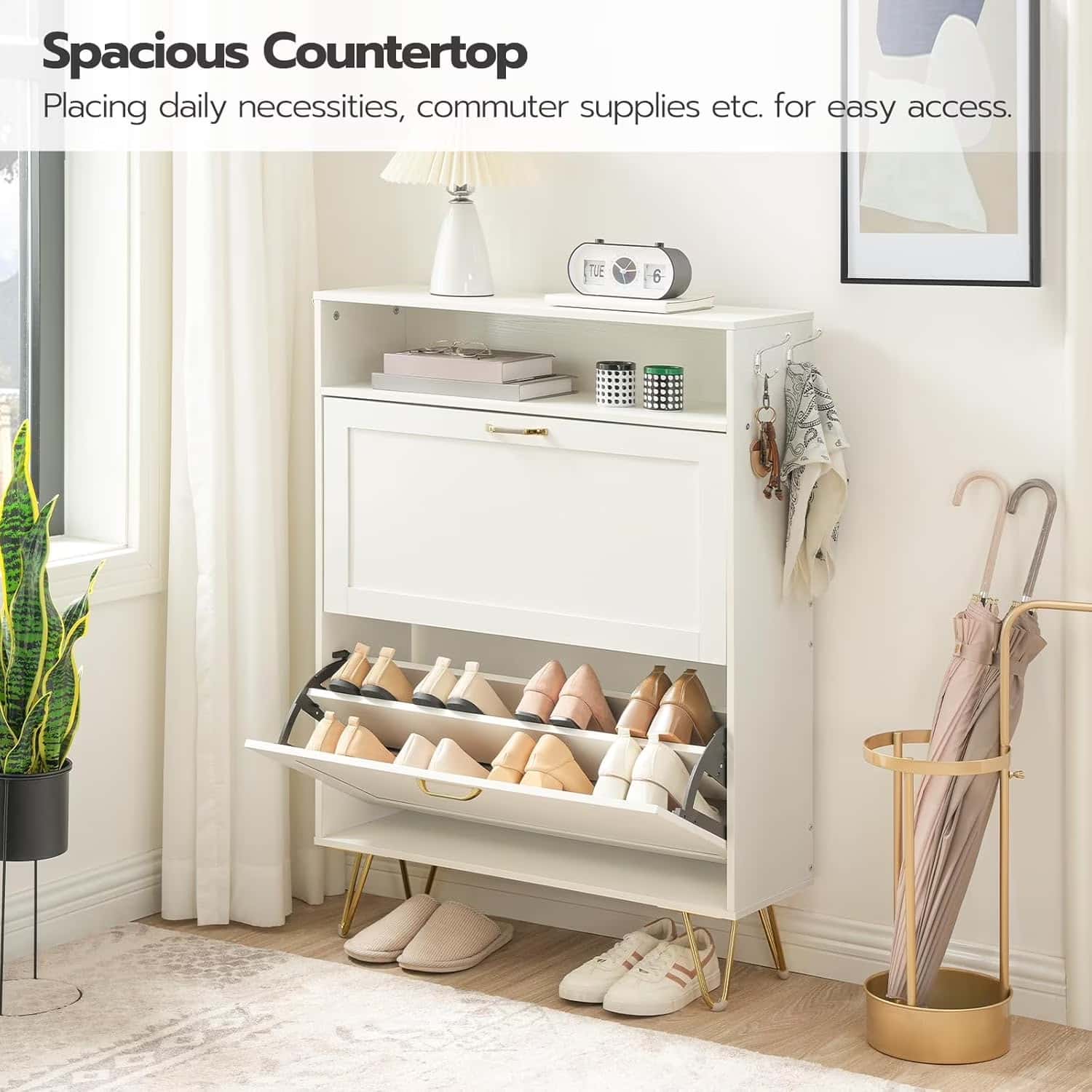 White shoe cabinet with open door showing shoes, slippers, and an umbrella stand in a room.