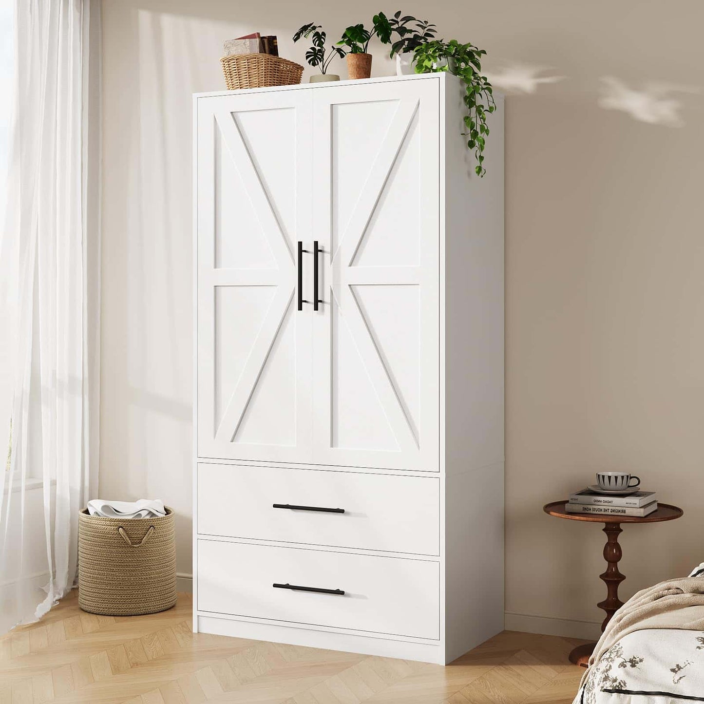 White wardrobe with black handles in a room with a side table and basket.