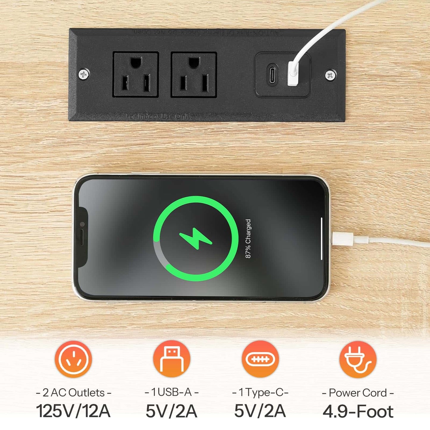 Power outlet with multiple ports and a smartphone charging on a wooden surface
