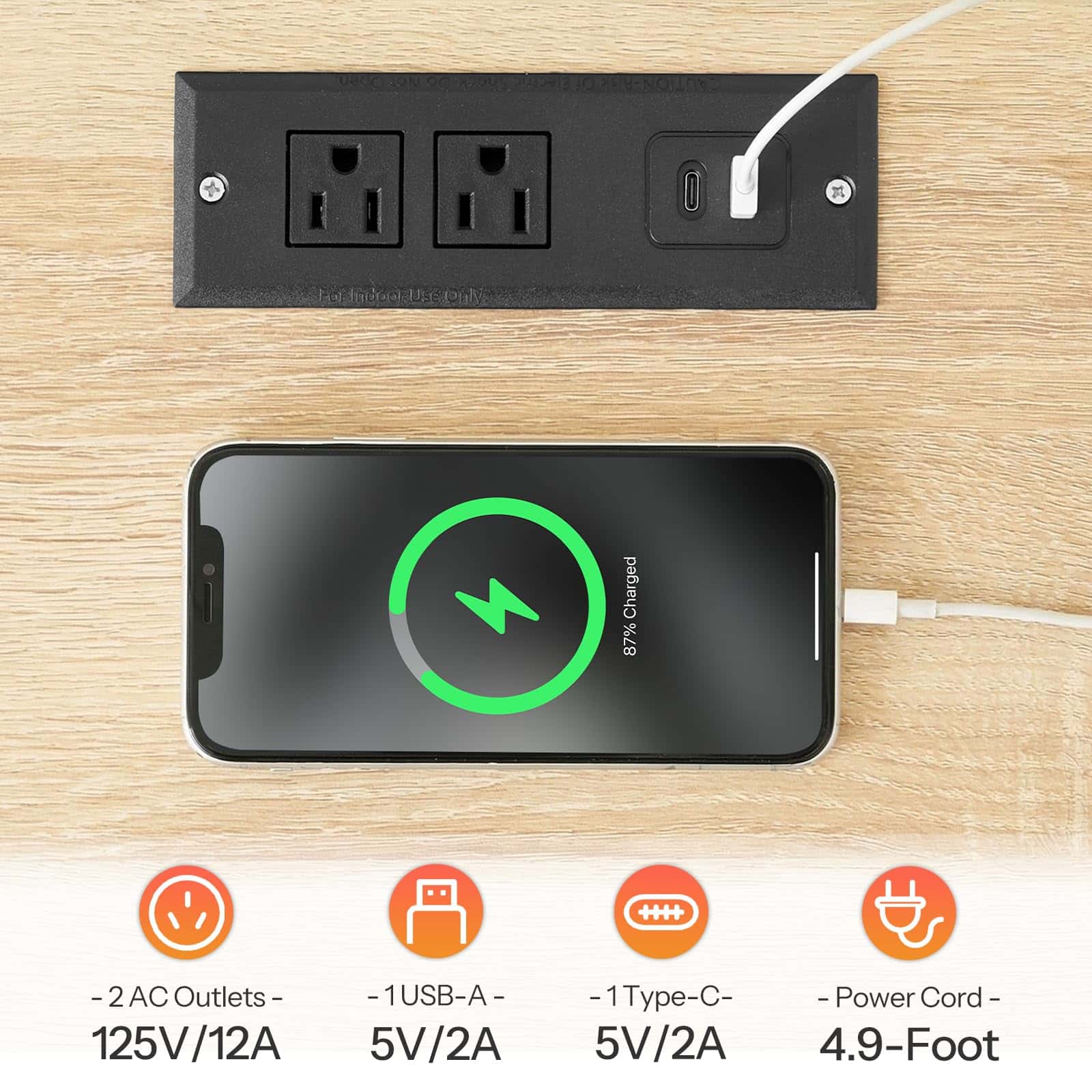 Power outlet with multiple ports and a smartphone charging on a wooden surface