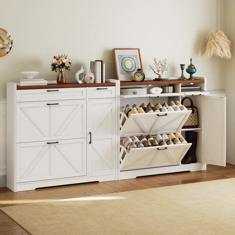 White storage cabinet with open shoe rack in a room with decor items on top