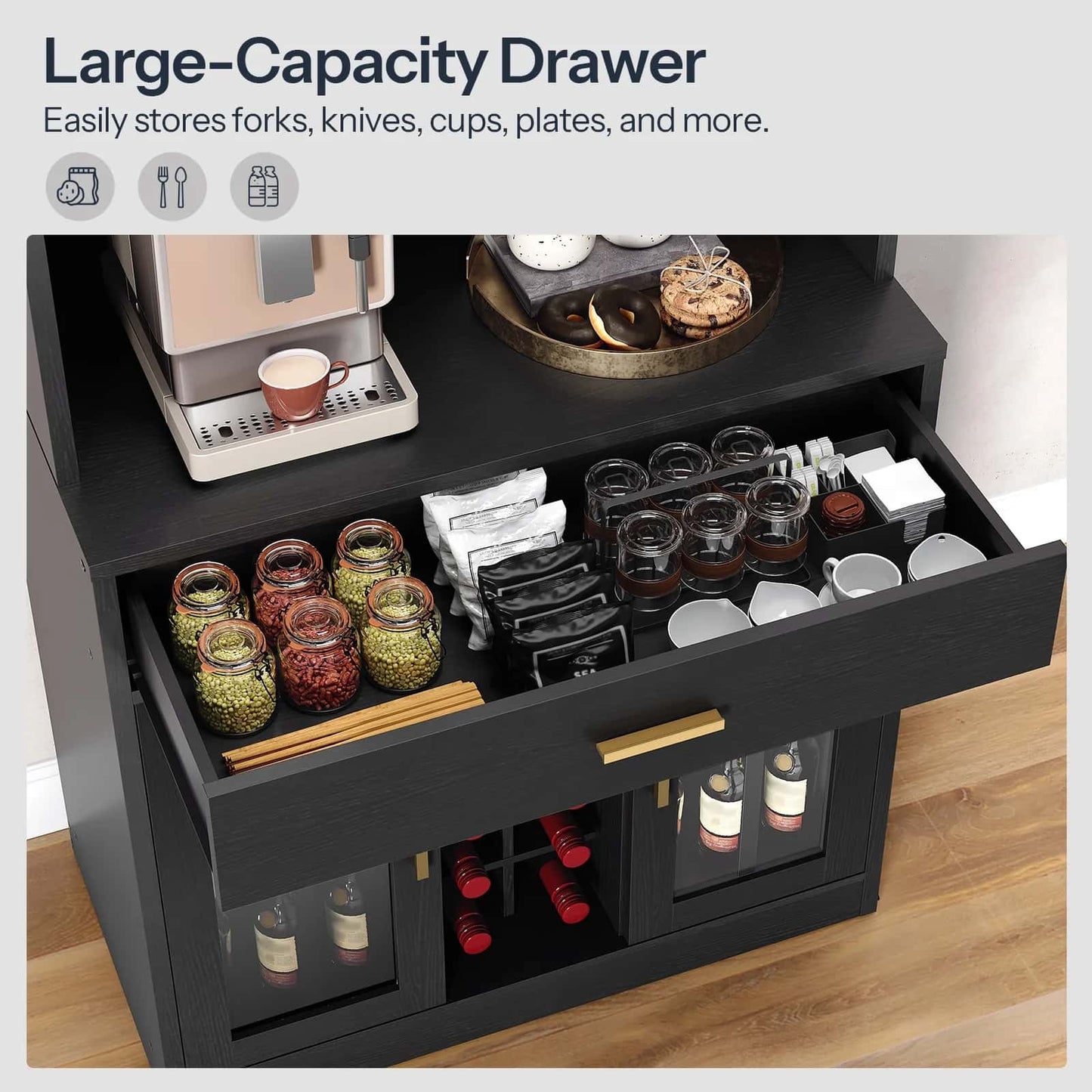 Black cabinet with open drawer containing kitchen items on a wooden floor.