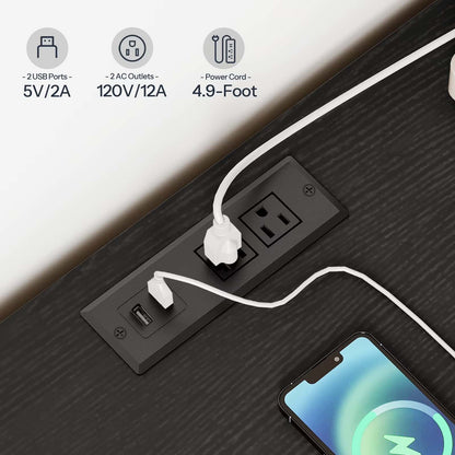 Power strip with multiple outlets and ports on a desk with a smartphone plugged in.