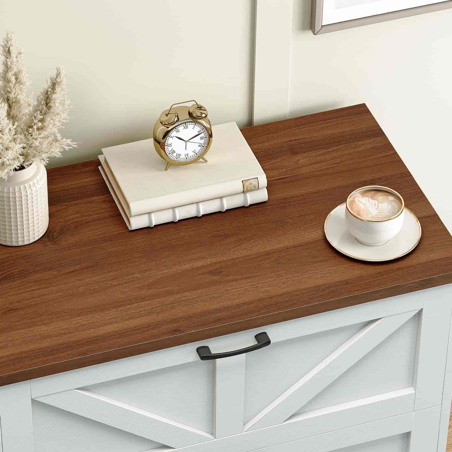 Wooden desk with a clock, books, and a cup of coffee on a white wall background