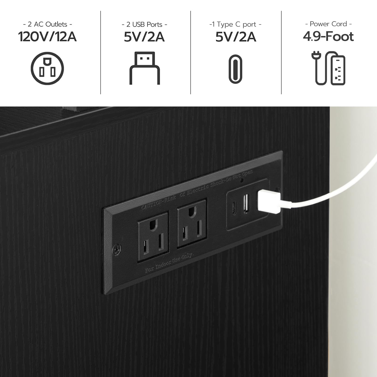 Black wall outlet with multiple ports on a wooden surface