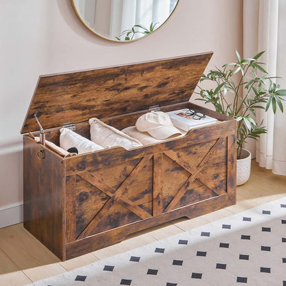 Wooden storage bench with items inside in a room with a mirror and plant.