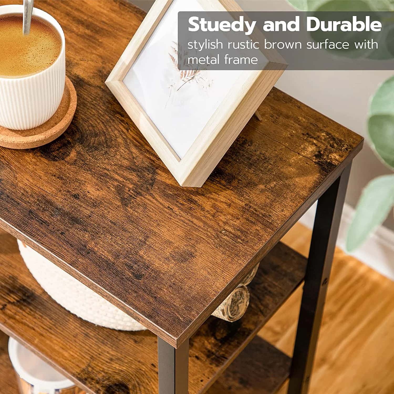 Wooden side table with a metal frame, featuring a framed picture and a cup on a saucer.
