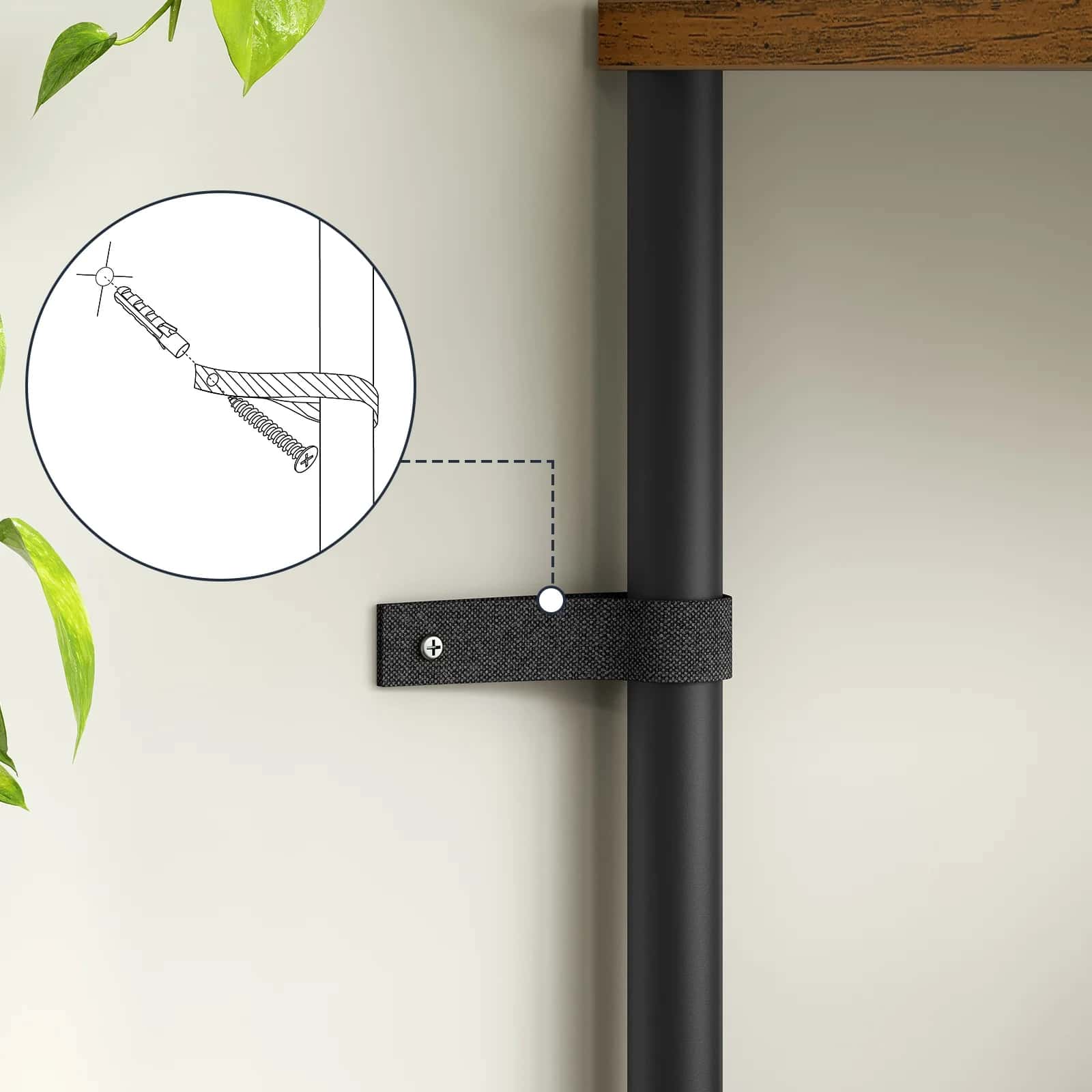 Black metal bracket attached to a vertical rod with a white background and plant leaves.