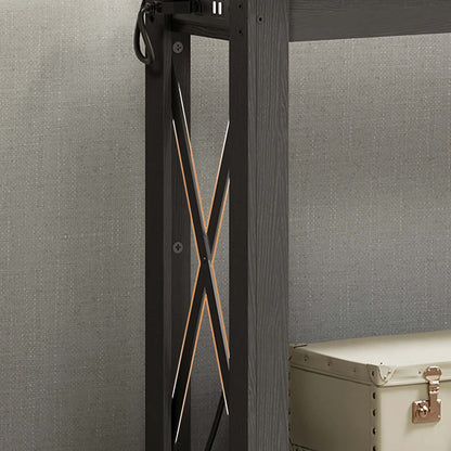 Black metal frame with decorative elements against a gray wall.