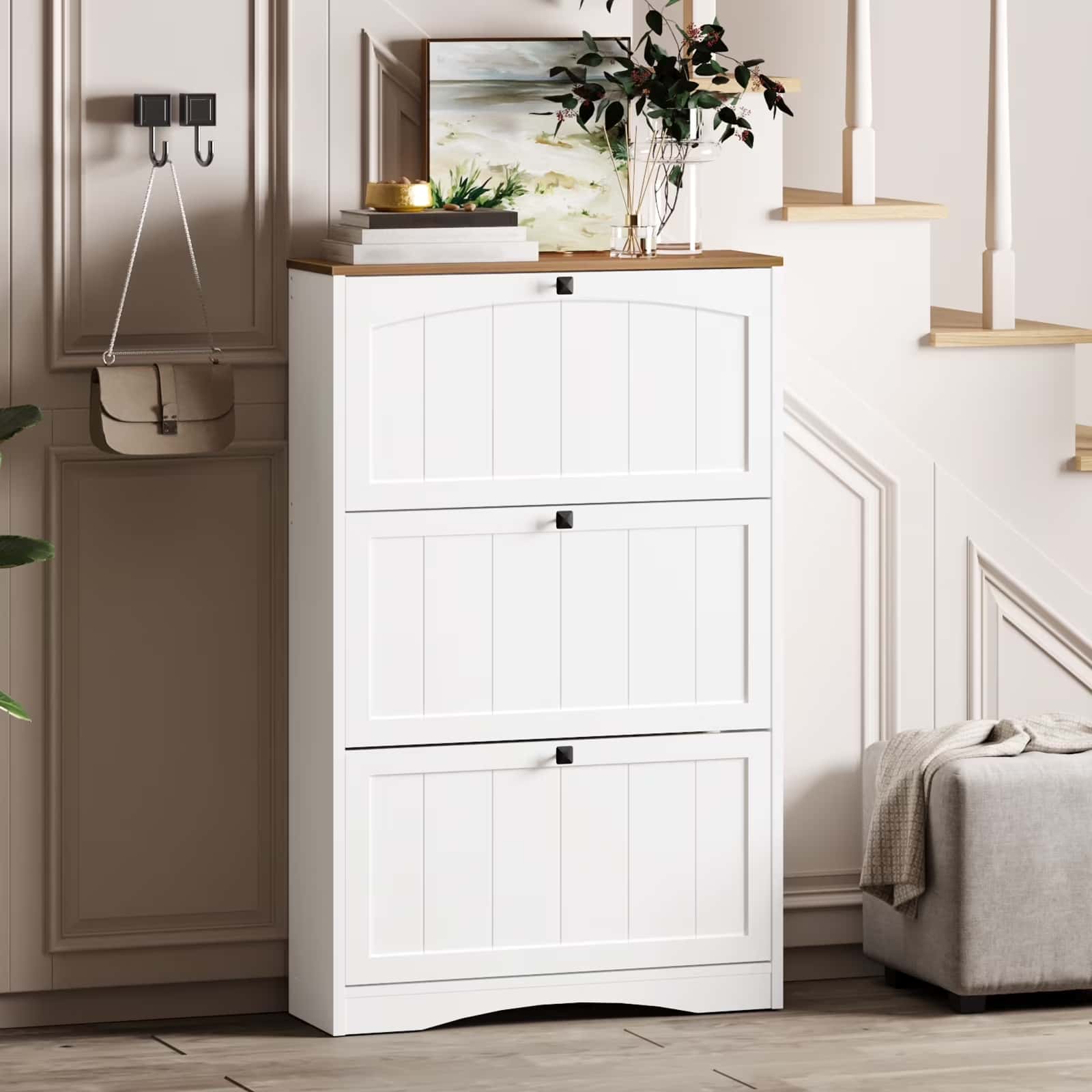 White shoe cabinet in a room with a bed and staircase