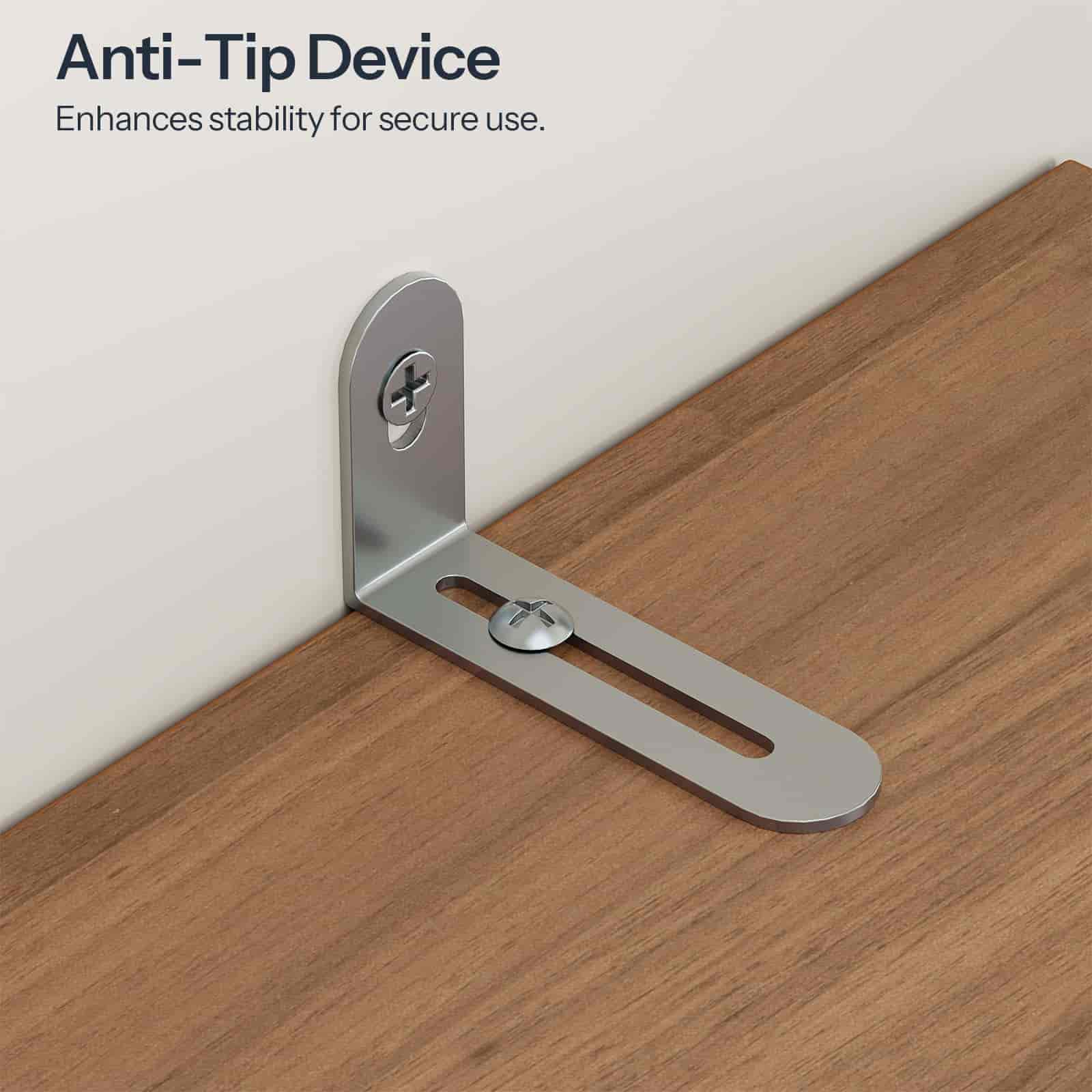 Anti-tip device on a wooden surface with text indicating its function.