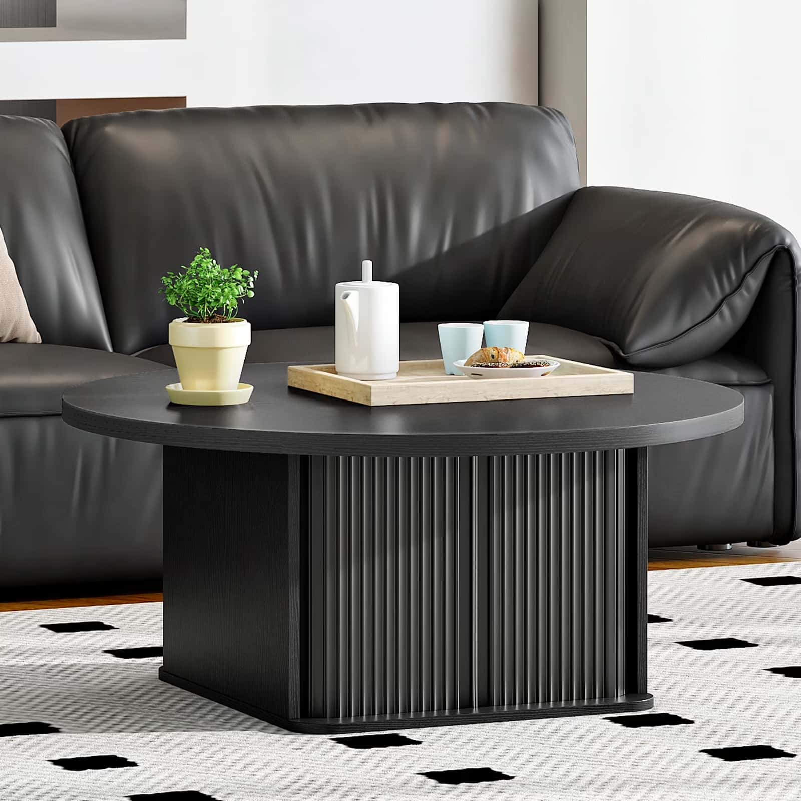 Black coffee table with decorative items in a living room setting