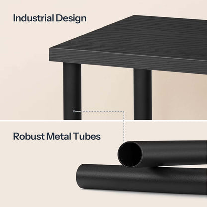 Black industrial-style table with robust metal tubes on a beige background