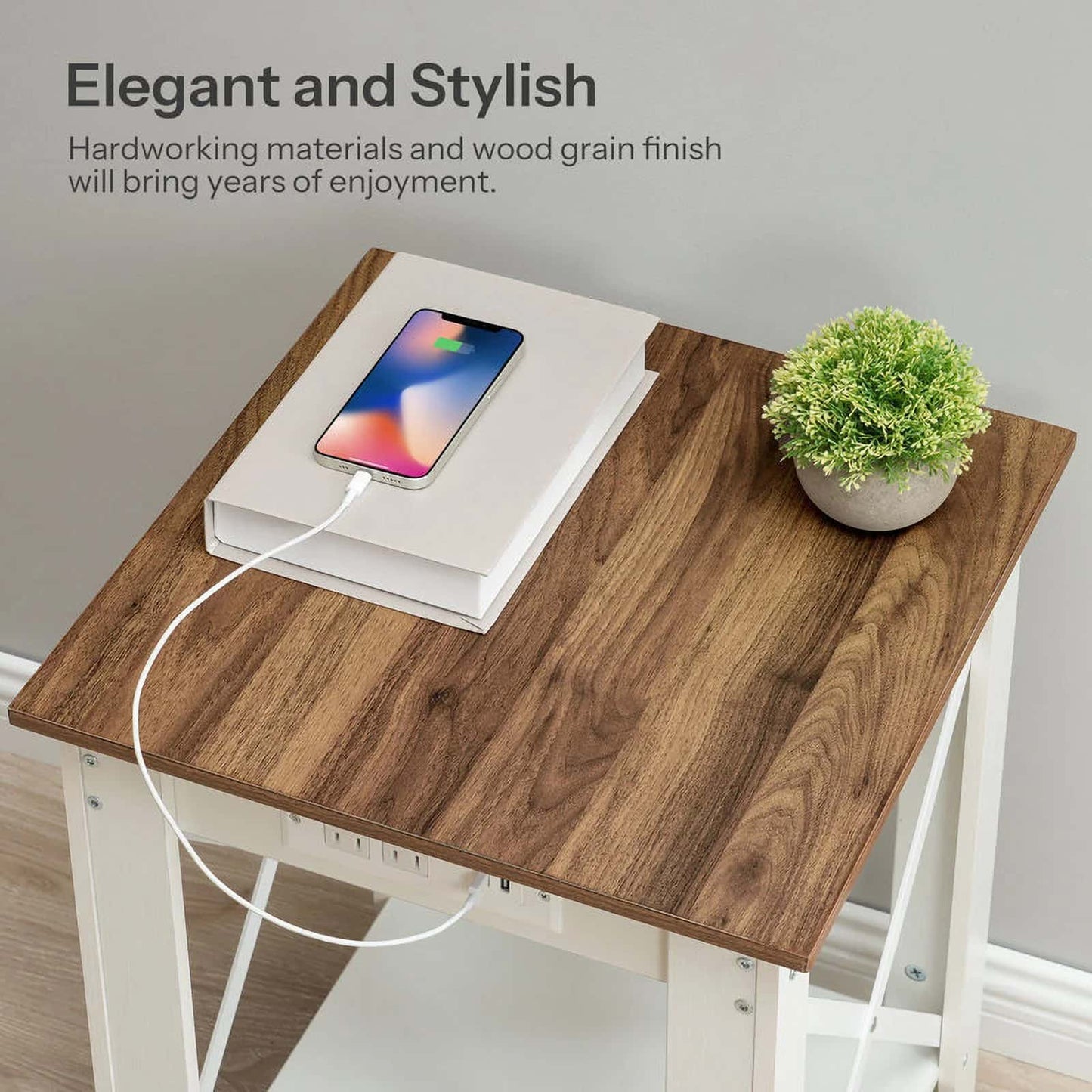 Wooden desk with smartphone, notebook, and plant on a neutral background