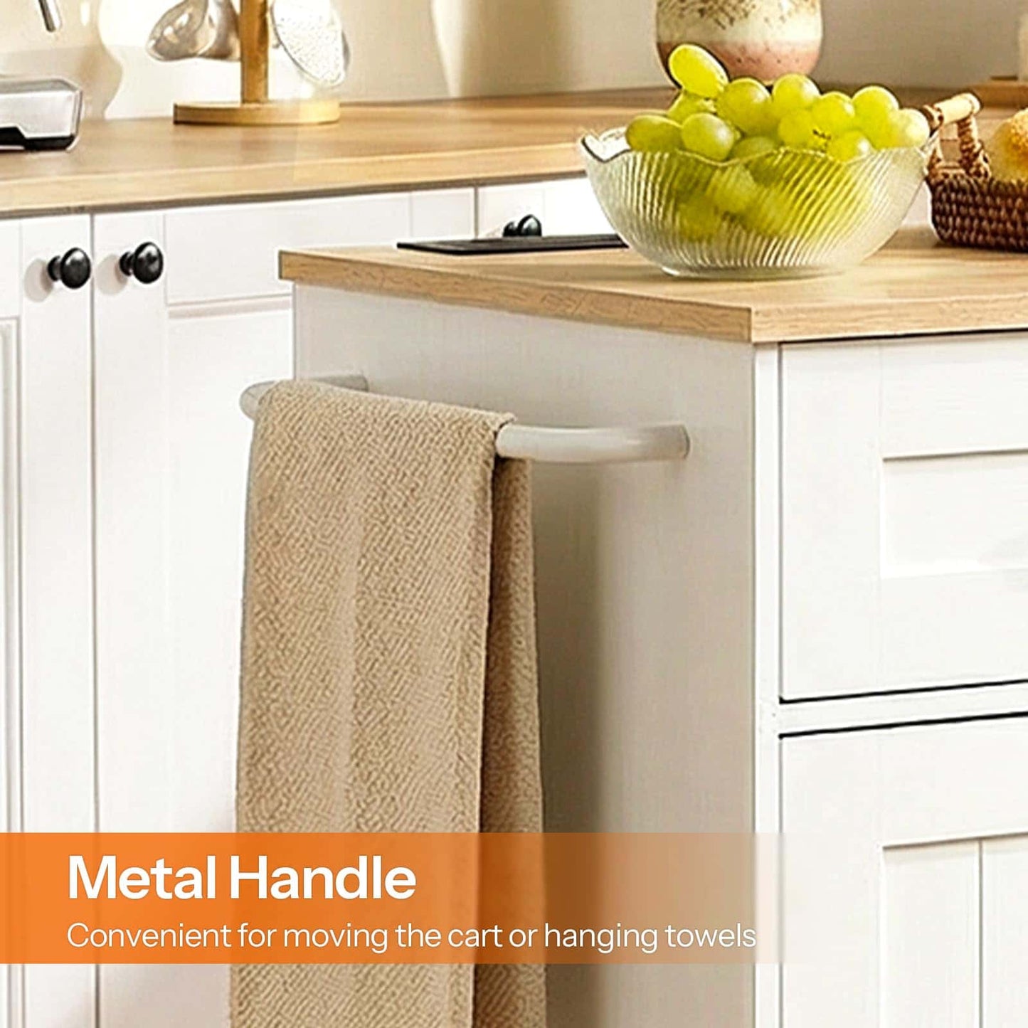 Kitchen counter with a towel rack holding a beige towel, grapes in a bowl, and decorative items.