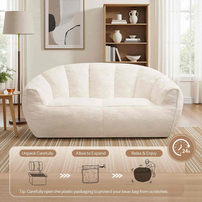 White bean bag chair in a living room setting with unpacking instructions displayed.