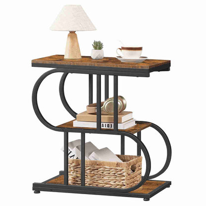 Three-tiered side table with wooden top and metal frame, featuring a lamp, books, and a basket.