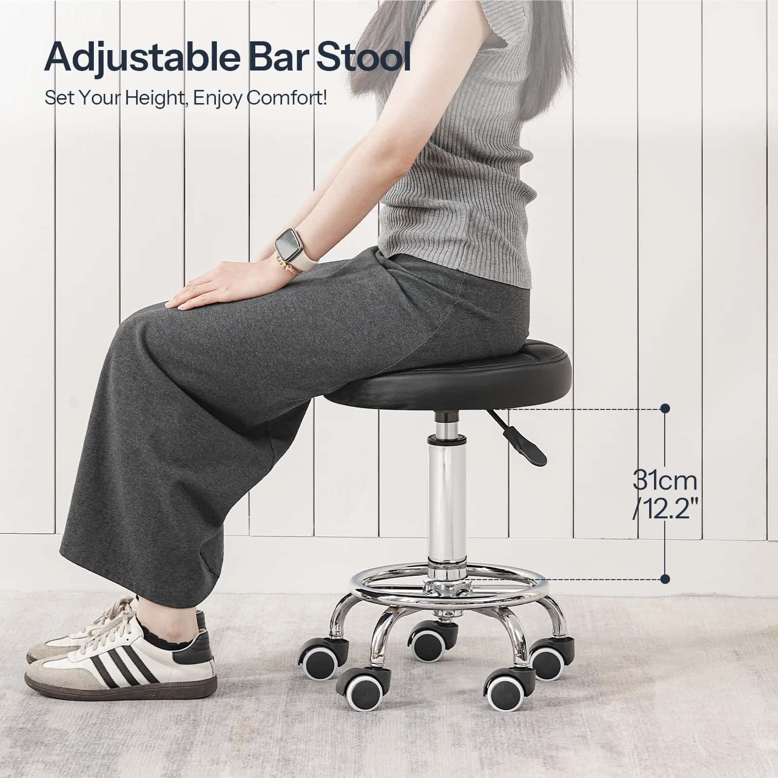 Person sitting on an adjustable bar stool with a white wooden floor background