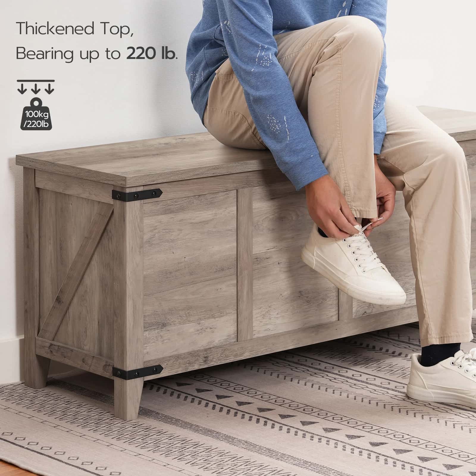 Person sitting on a wooden storage bench with text indicating weight capacity.