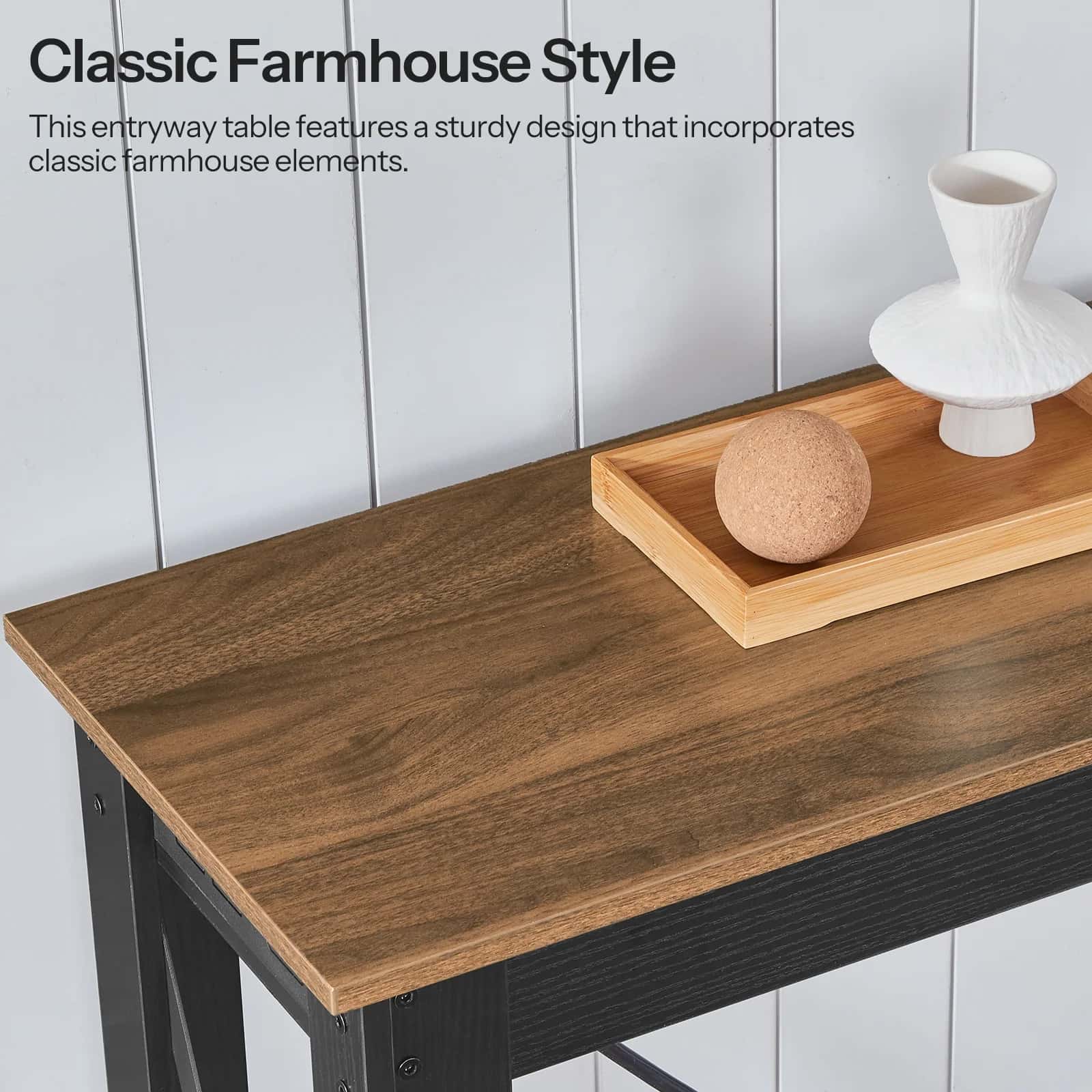 Wooden entryway table with decorative items against a white paneled wall, featuring text about classic farmhouse style.