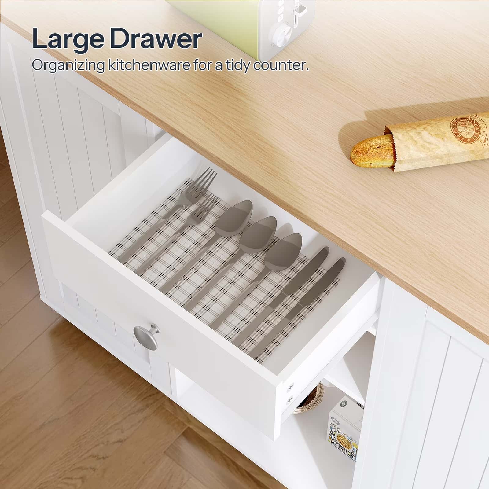Large drawer with organized cutlery on a kitchen counter.