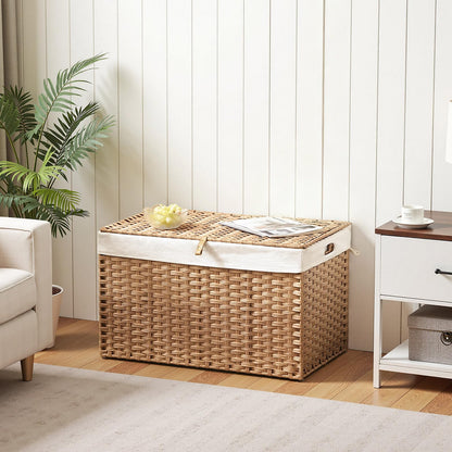 Wicker storage basket with a white liner in a room with a plant and furniture.