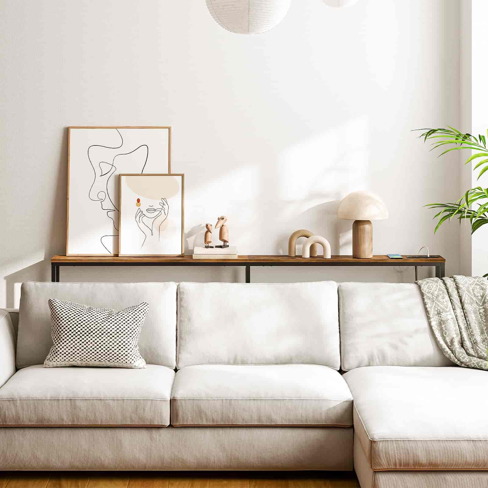 Modern living room with a white sofa, decorative pillows, and wall art.