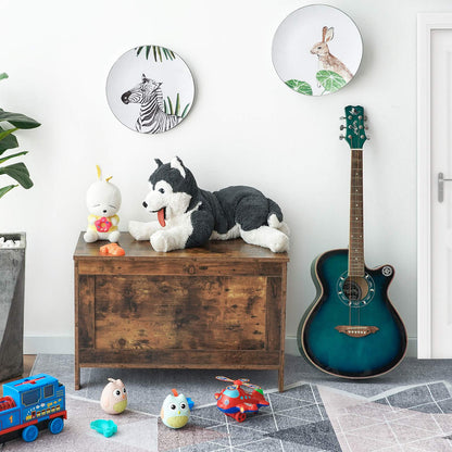 Children's room with toys, a guitar, and wall plates featuring animals.