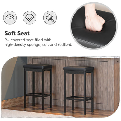 Two black bar stools with a soft seat feature, shown in a kitchen setting.