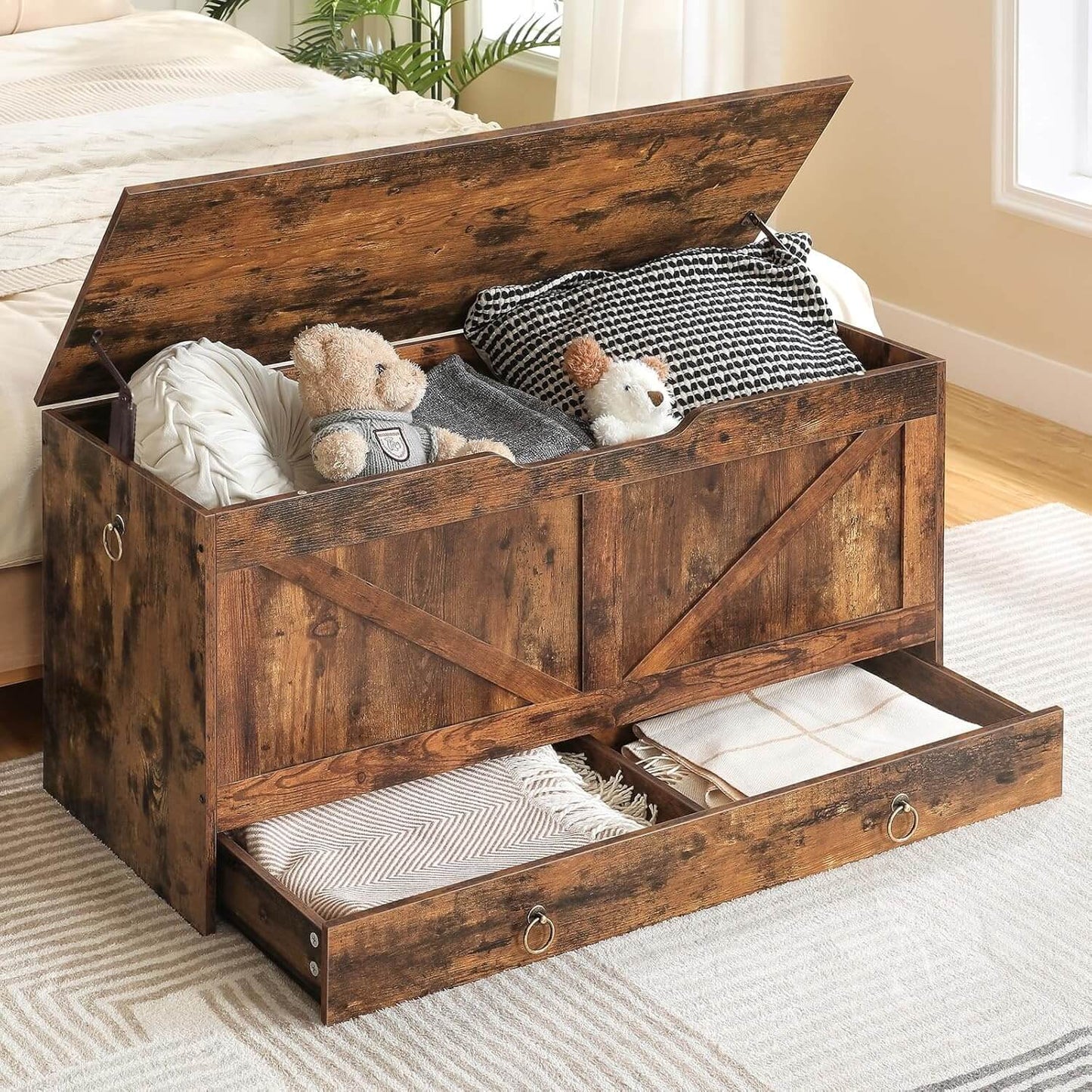 Wooden storage chest with toys and blankets inside, placed on a carpeted floor.
