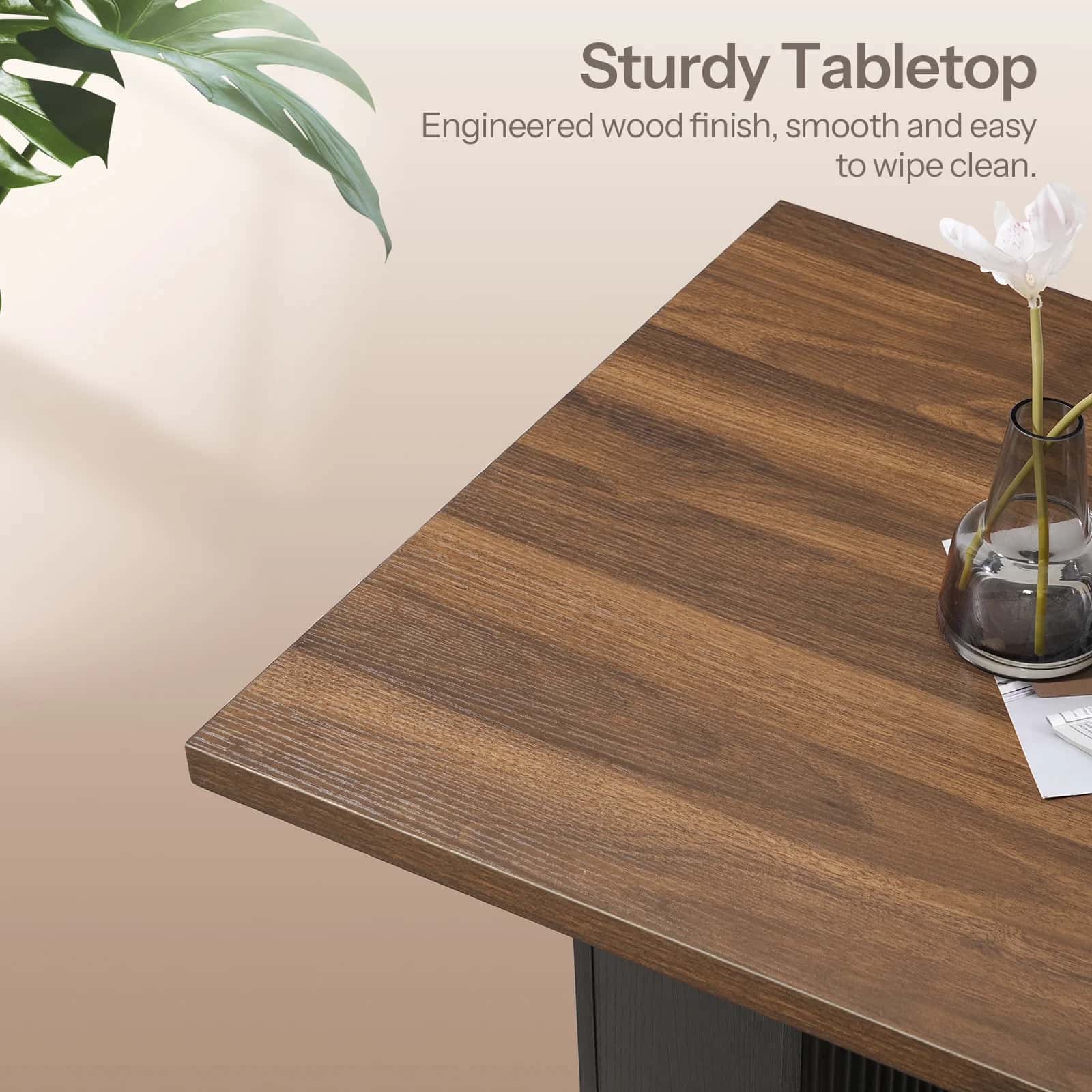 Wooden table surface with a vase and plant on a neutral background