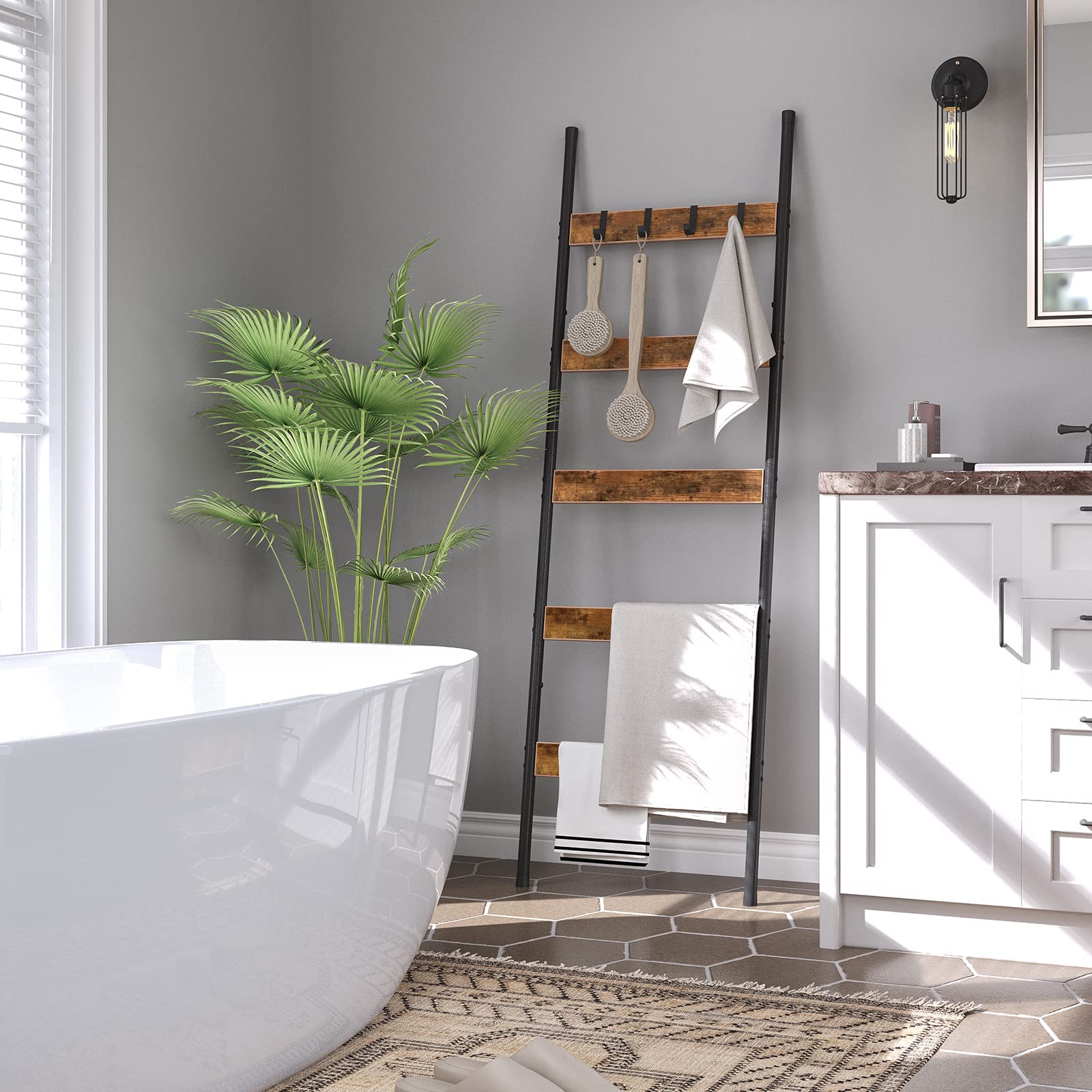 Elegant bathroom towel ladder rack leaning against the wall next to a modern luxury bathtub.